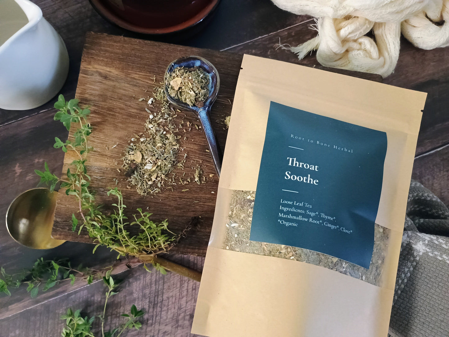 Herbal tea packaging with dried herbs on a wooden surface