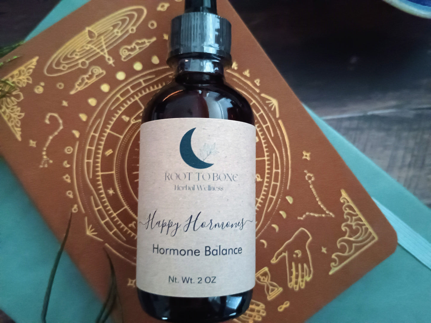 Bottle of 'Happy Hormones Hormone Balance' by Root to Bone on a decorative mat.