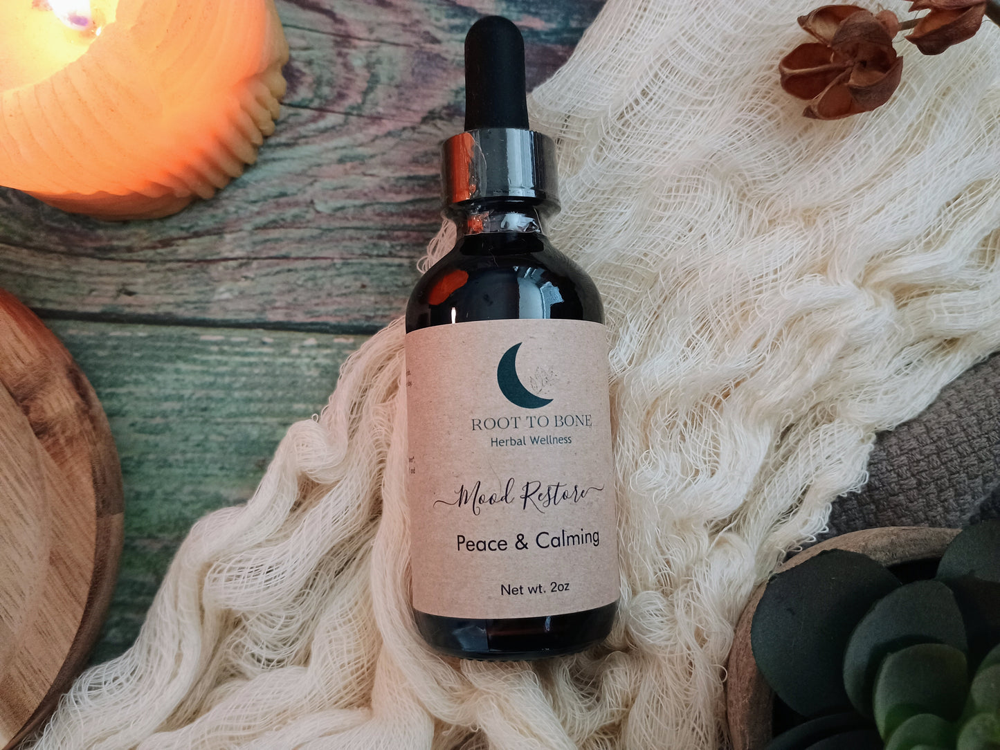 Bottle of 'Peace & Calming' herbal wellness supplement on a textured surface with decorative elements.