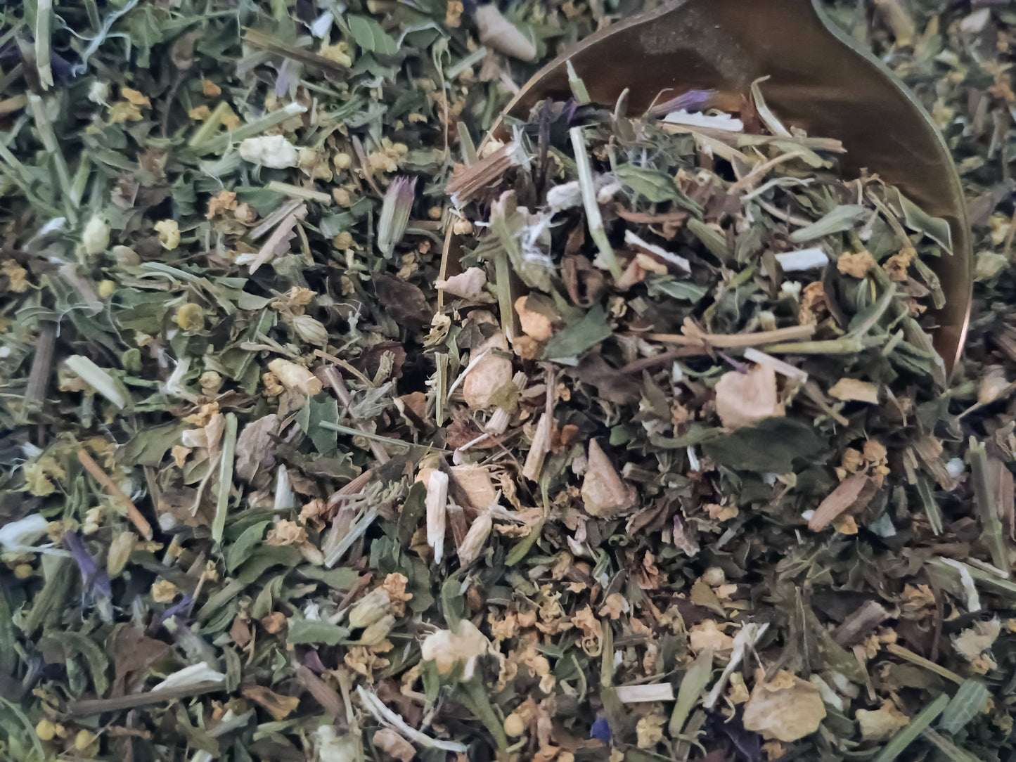 Close-up of dried herbs in a wooden spoon