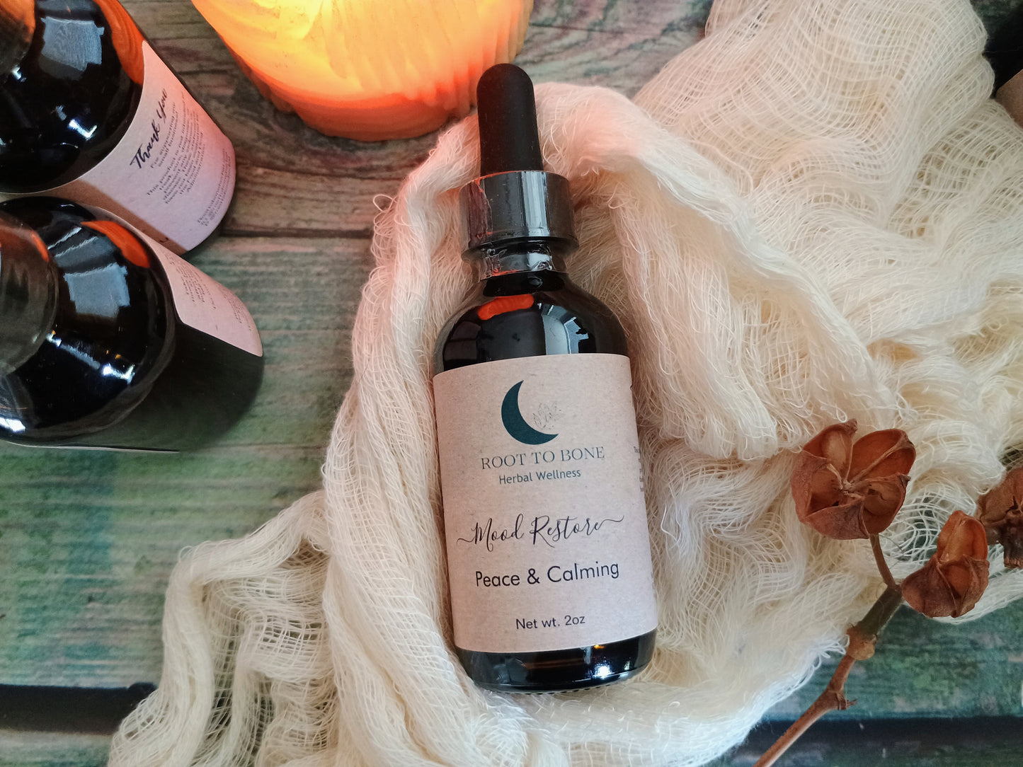 Bottle of 'Root to Bone' herbal supplement with a label on a textured surface.