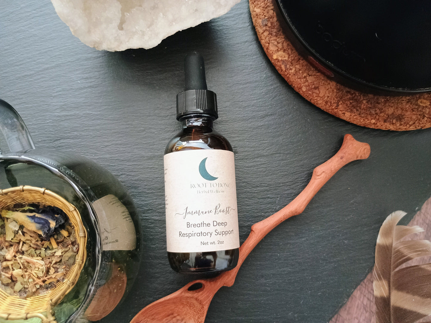 Bottle of tincture with dropper on a dark surface with natural elements