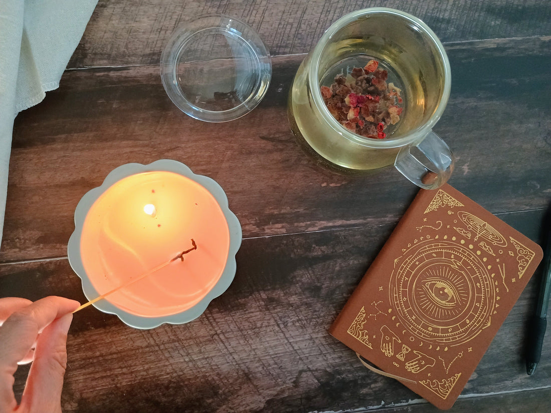candle light, a cup of tea and a notebook for journaling 