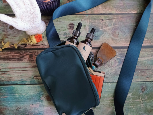 purse with spilled contents: keys, wallet, and 2 tincture bottles