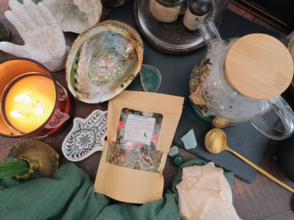 Tea packaging on a table with a lit candle and decorative items