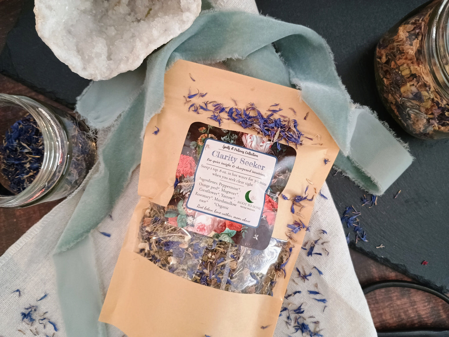 Herbal tea package with dried herbs on a stone surface