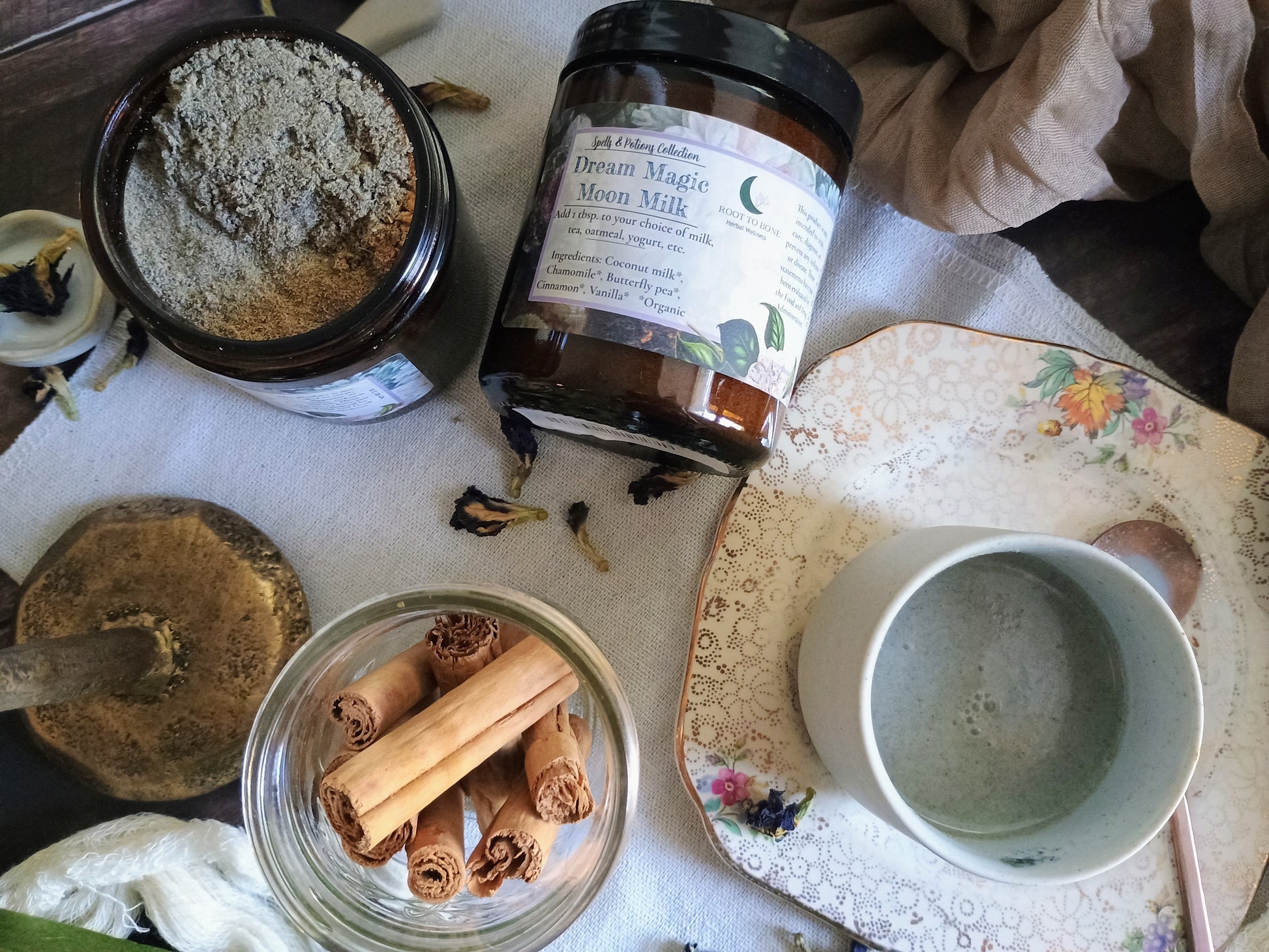 Jars with ingredients and a cup on a textured surface