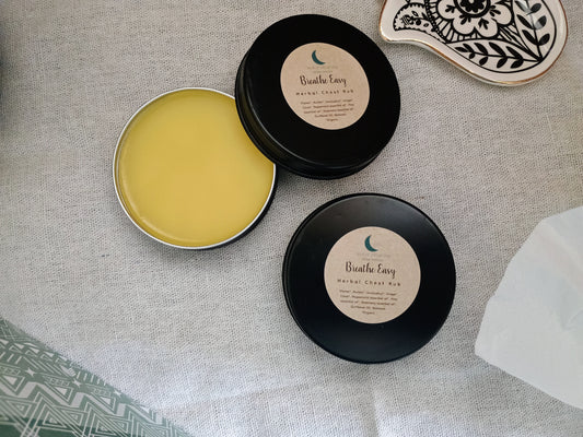 Two black tins with yellow contents on a textured surface