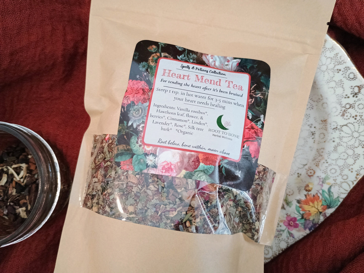 Heart-Mind Tea package with floral design and text on a red fabric background