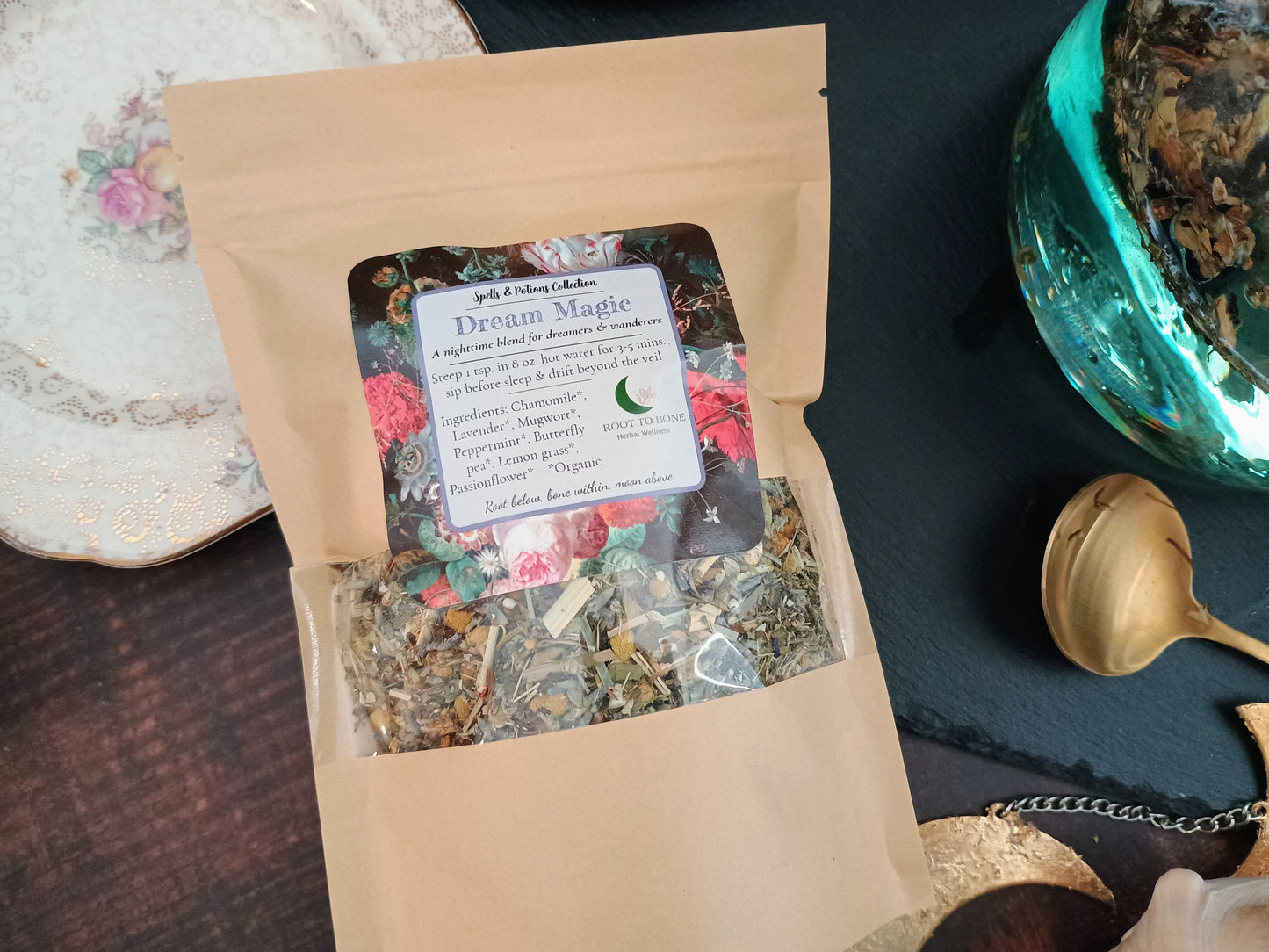 Tea package labeled 'Dream Magic' with floral design on a dark surface.