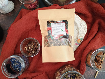 Tea packaging with dried herbs on a red fabric background