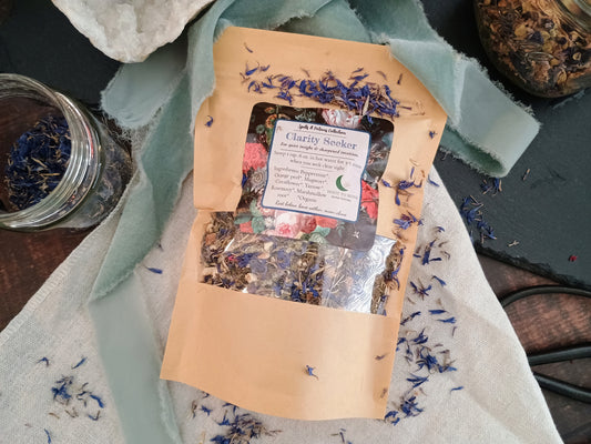 Tea package labeled 'Clarity Seeker' with dried herbs on a textured surface