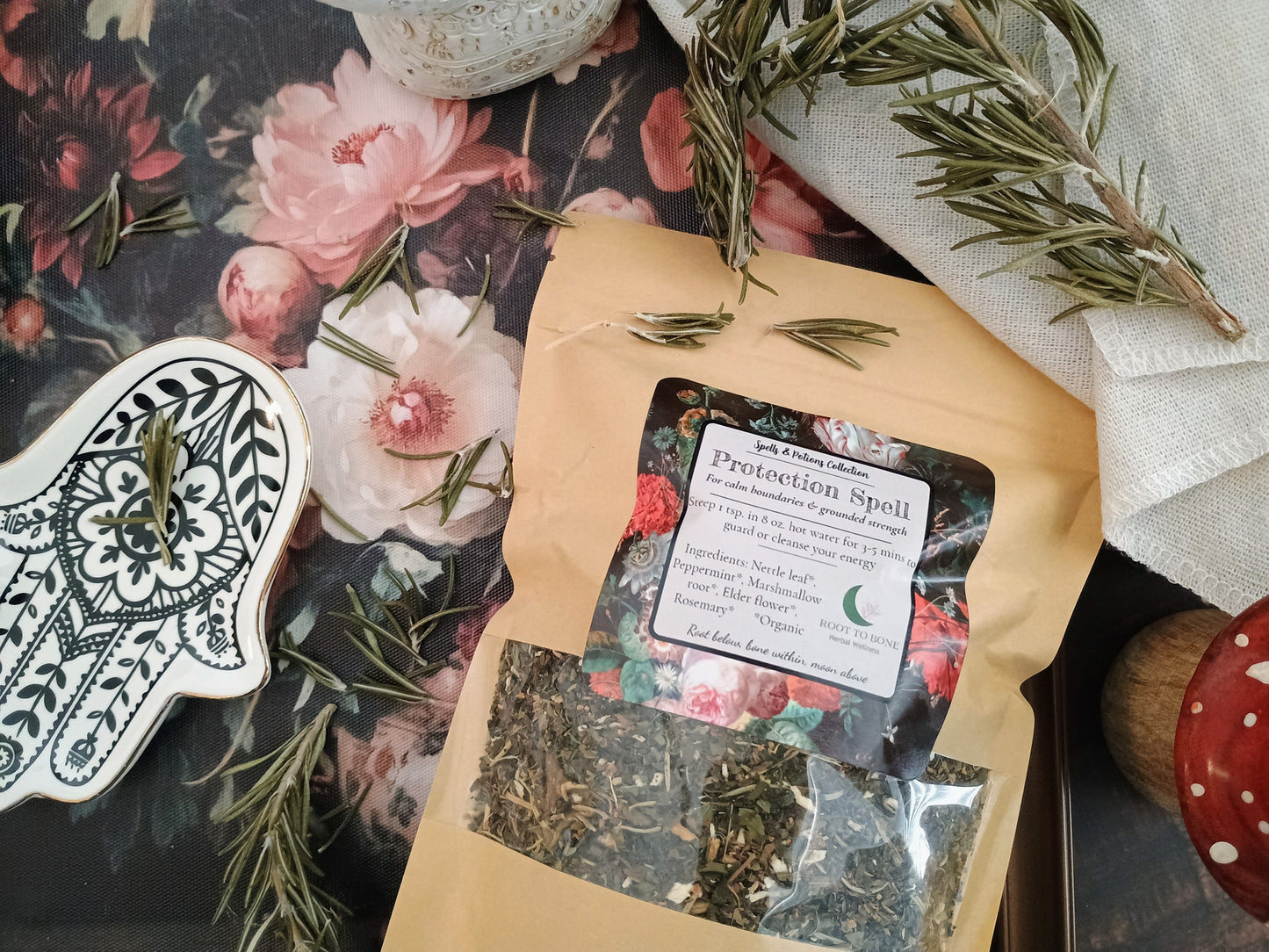 Herbal package with a label on a decorative surface with flowers and herbs.