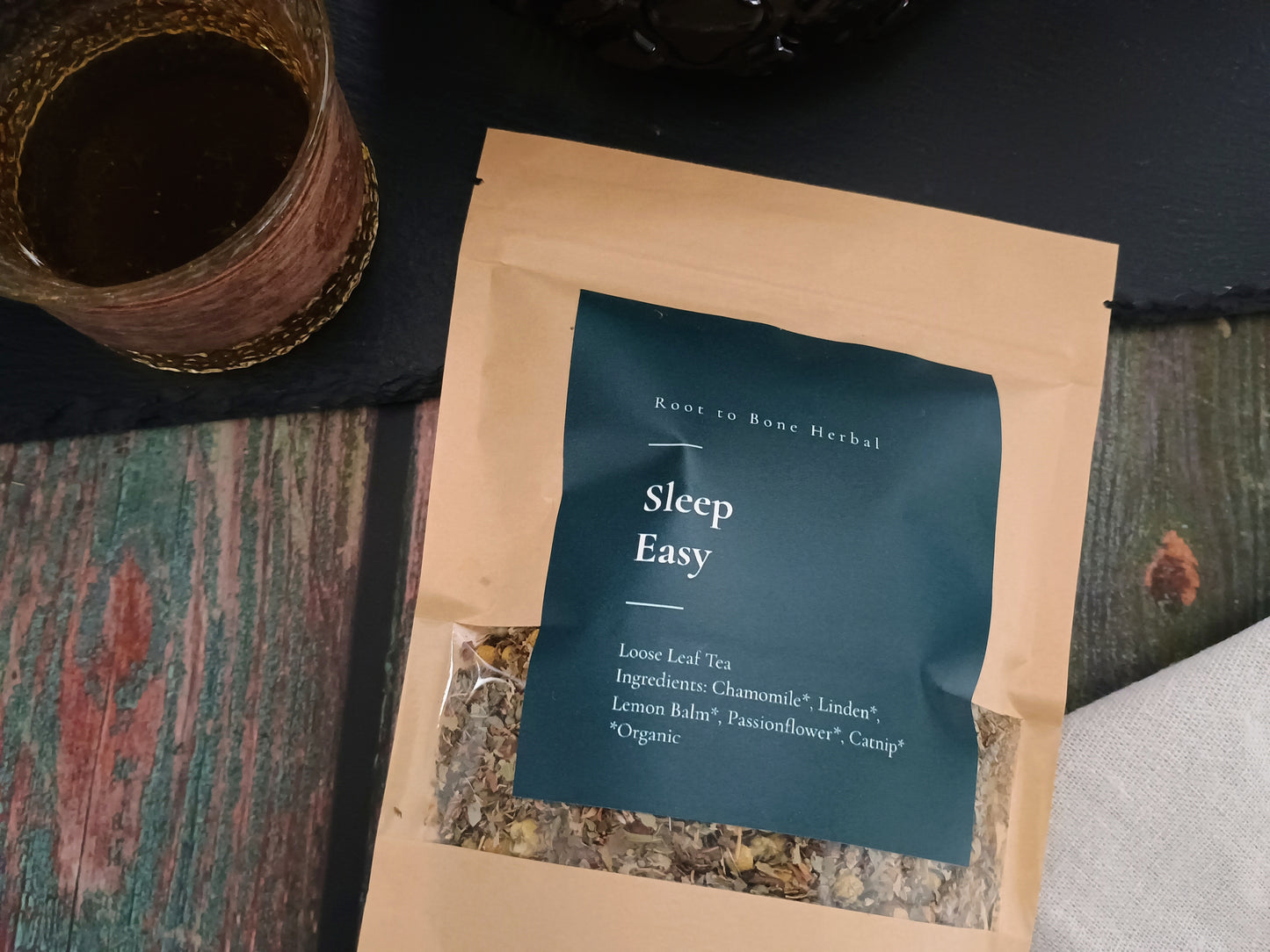 Sleep Easy tea package with a cup of tea on a textured surface