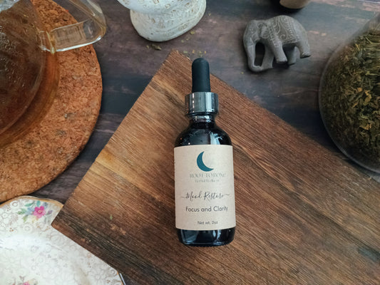 Bottle of 'Mood Restore Focus & Clarity' on a wooden surface with decorative items in the background