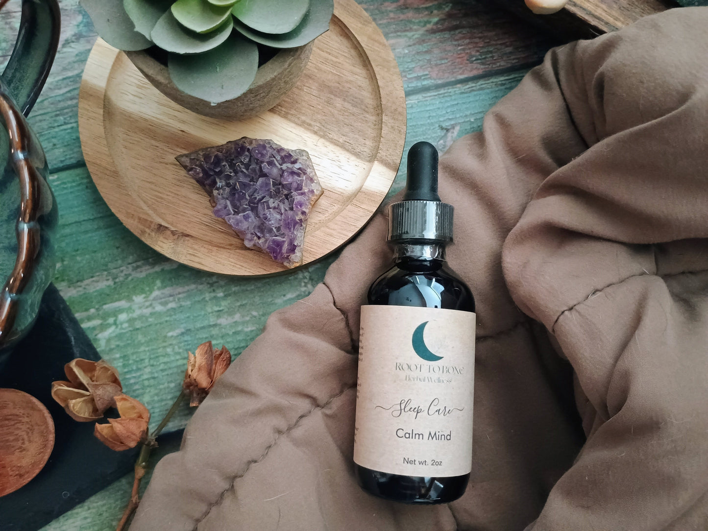Bottle of 'Calm Mind' supplement on a textured surface with decorative elements.