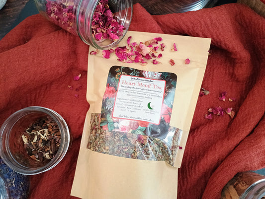 Tea packaging with floral elements on a red fabric background