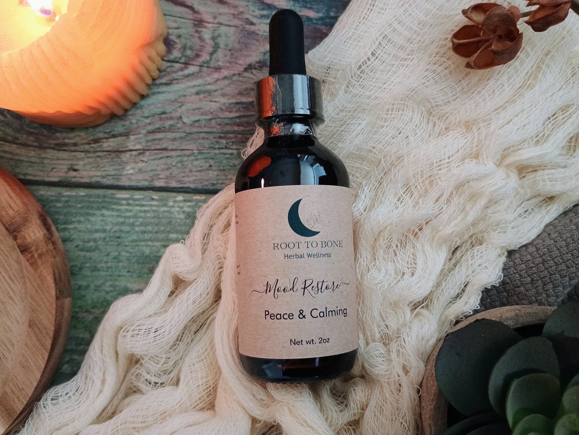 Bottle of 'Peace & Calming' herbal wellness supplement on a textured surface with decorative elements.