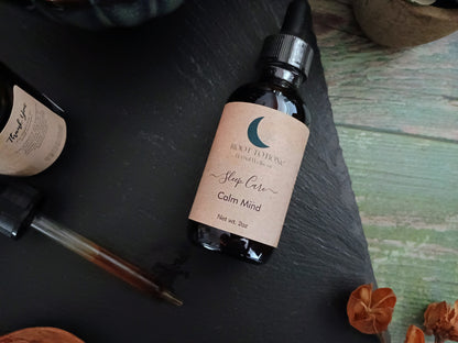 Bottle labeled 'Sleep Care Calm Mind' on a dark surface with decorative elements.