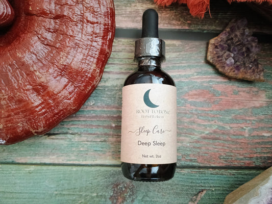 Bottle of 'Sleep Care Deep Sleep' on a wooden surface with a large reishi mushroom and amethyst
