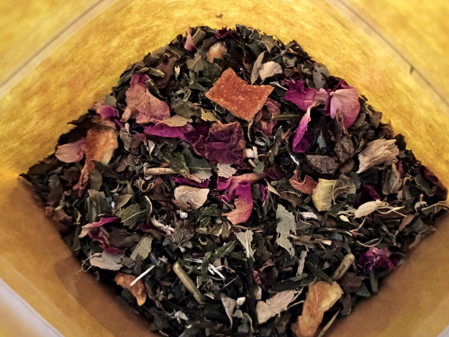Assorted dried herbs and flowers in a wooden container