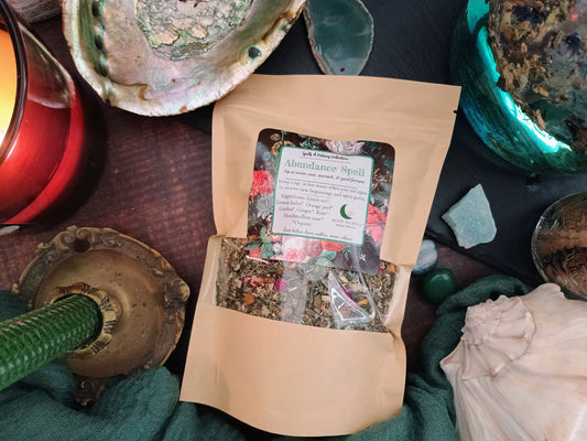 Open package of 'Abundance Spell' with a label on a textured surface