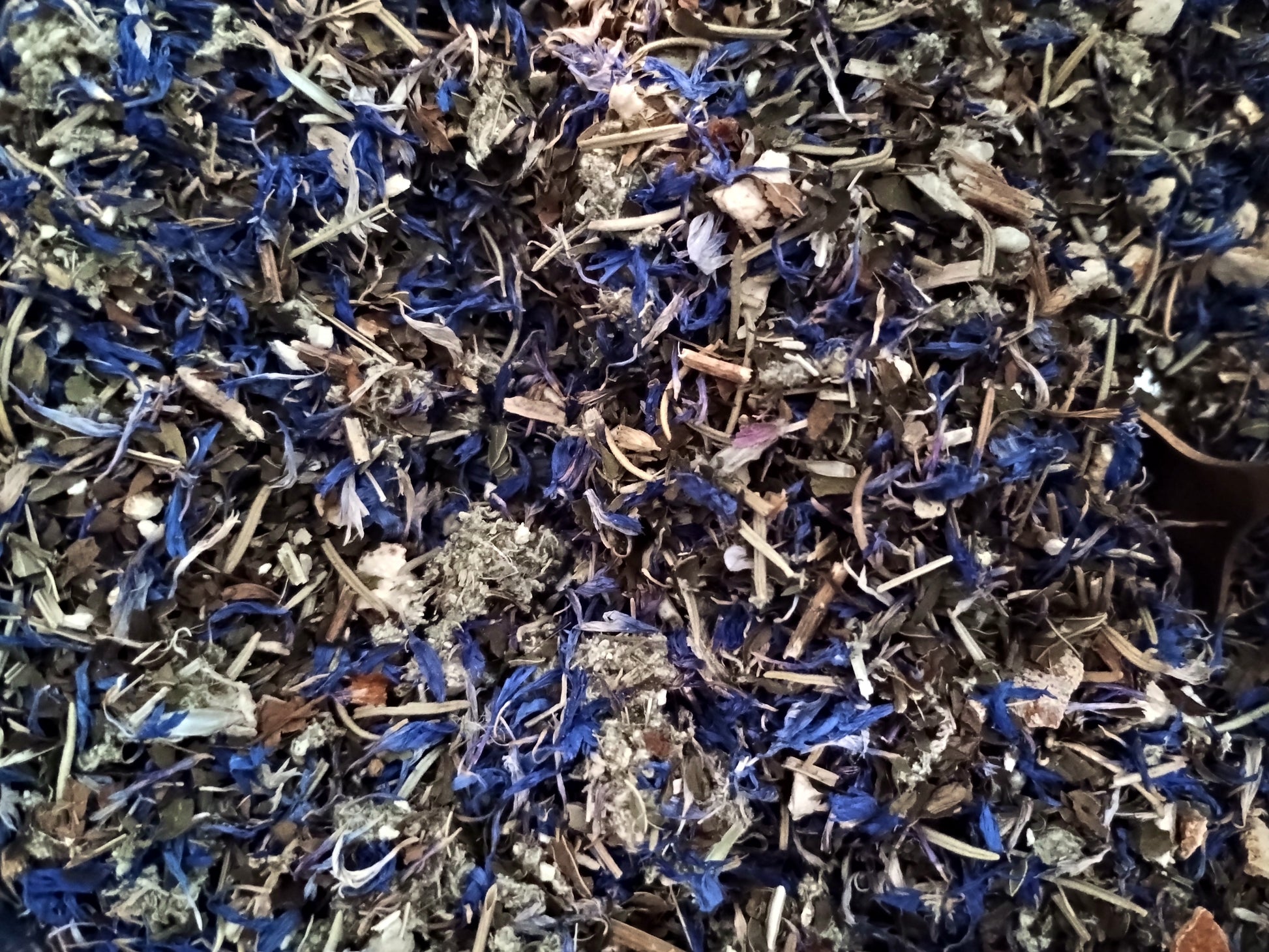Close-up of a mix of dried herbs with blue and brown tones