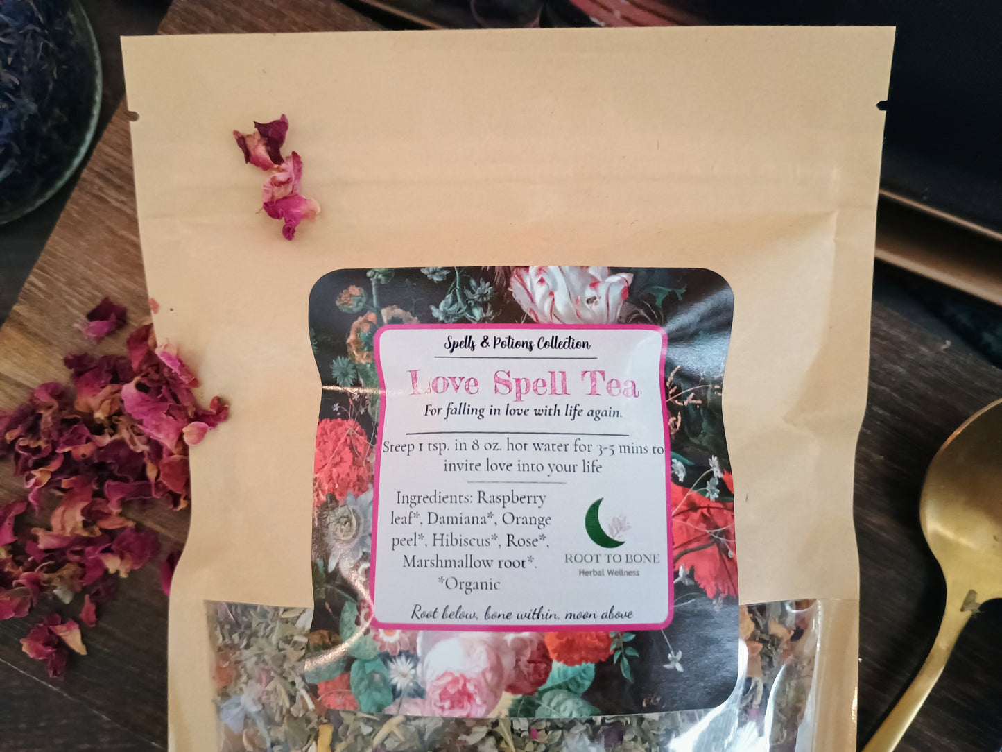 Tea package with a label on a wooden surface with dried flowers.