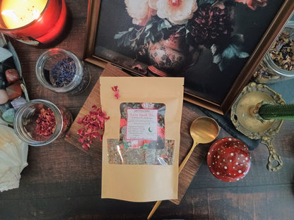 Herbal tea package on a wooden table with decorative items