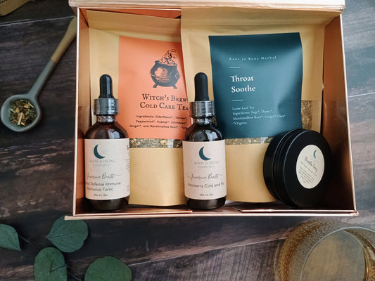 Herbal wellness kit with bottles, tea bags, and a salve in an open box on a wooden surface.