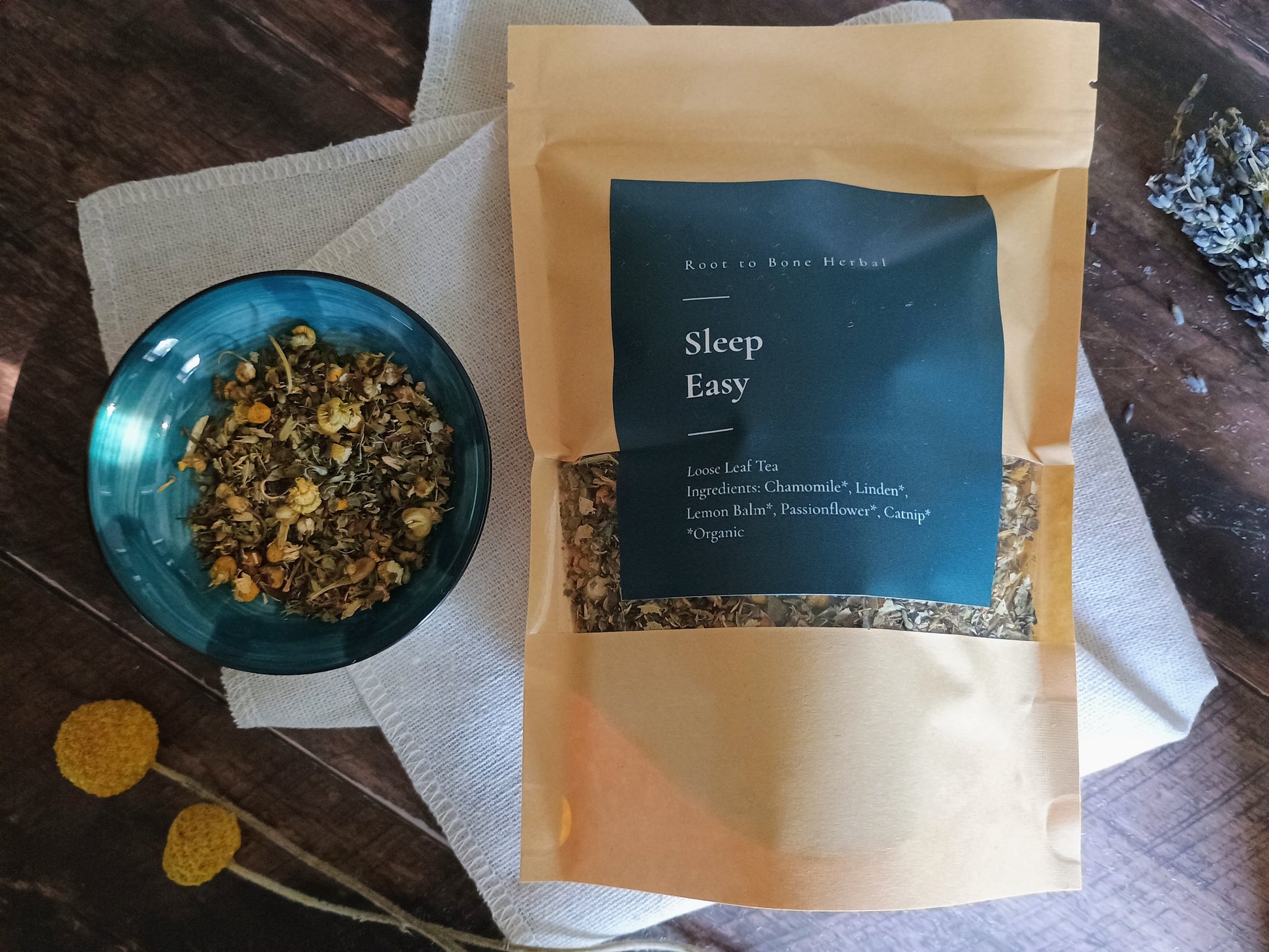 Sleep Easy tea package with a bowl of dried herbs on a wooden surface